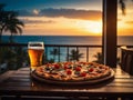 A pizza and mug of beer served on a balcony with ocean beach sunset view. Ideal for food, dining, and sunset relaxation concepts