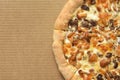 Pizza with mushrooms on corrugated fiberboard background