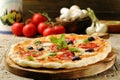 Pizza with mushrooms, olives and basil on wooden table Royalty Free Stock Photo