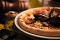 Pizza with mussels and shirmps on wooden board. sea food background