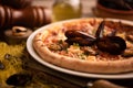 Pizza with mussels and shirmps on wooden board. sea food background