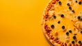 Pizza with olives and cheese on a yellow background