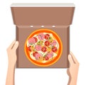 Pizza in the opened cardboard box.