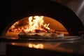 Pizza in the oven with a fire in the background. Restaurant, chefs making a pizza close up in a pizza oven with fire, AI Generated