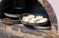 A pizza oven with a tray of dough balls on top Royalty Free Stock Photo