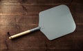 Pizza peel paddle italian style with wood handle on wooden table Royalty Free Stock Photo