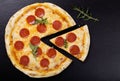 Pizza peperoni on stone black try with rocket and mozzarella cheese Royalty Free Stock Photo