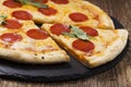 Pizza peperoni on stone black try with rocket and mozzarella cheese Royalty Free Stock Photo