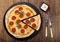 Pizza peperoni on stone black try with rocket and mozzarella cheese Royalty Free Stock Photo