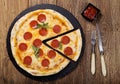 Pizza peperoni on stone black try with rocket and mozzarella cheese Royalty Free Stock Photo