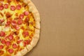 Pizza pepperoni on brown corrugated fiberboard background