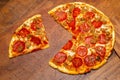 Pizza pie with a quarter removed to demonstrate math fractions. Royalty Free Stock Photo