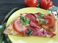 pizza piece with sausage fork knife ingredient on a black wooden Royalty Free Stock Photo