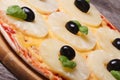 Pizza with pineapple and black olives on the old table Royalty Free Stock Photo