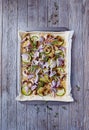 Pizza prepared to bake. Rustic wooden background.