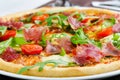 Pizza With Prosciutto, Fresh Tomatoes And Rucola