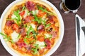 Pizza With Prosciutto, Fresh Tomatoes And Rucola