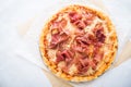 Pizza with prosciutto (parma ham) on white background top view