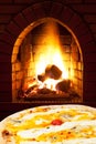 Pizza quatro formaggi and open fire in stove Royalty Free Stock Photo