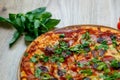 Pizza quattro carni, sausage, salami, ham, tomato sauce and parsley detail Royalty Free Stock Photo