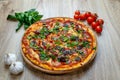 Pizza quattro carni, sausage, salami, ham, tomato sauce and parsley top angle Royalty Free Stock Photo