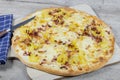Pizza with raclette cheese, potatoes and bacon