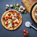 Pizza ready to eat on a stone undergound with wooden board