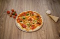 Pizza with red pepper, red sauce, cheese wider angle