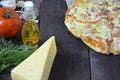 Pizza salami cheese ham. Hot Homemade Pepperoni Pizza Ready to Eat . with ingredients for cooking, greens, garlic, tomato, cheese Royalty Free Stock Photo