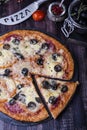 Pizza with salami, mozzarella, olives and basil Royalty Free Stock Photo