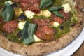 Pizza with salami and pesto Royalty Free Stock Photo