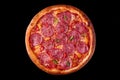 pizza with salami sausage and chili pepper top view on black background Royalty Free Stock Photo