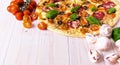 Pizza with Salami Vegetables and Spices on a white wooden background with copy space. Royalty Free Stock Photo