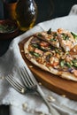 Pizza with salmon, asparagus and pine nuts