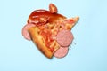 Pizza, sausage, sauce and tomato on blue background