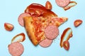 Pizza, sausage, sauce and tomato on blue background