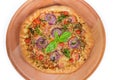 Pizza with sausage and thick outer ring on serving board Royalty Free Stock Photo