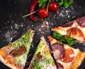 Pizza with sausage and vegetables on a black background. Royalty Free Stock Photo