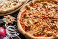 Pizza with seafood, mussels, tuna fish, sauce and cheese on wooden board over dark background. Fast food lunch for picnic company Royalty Free Stock Photo