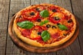 Pizza served on wooden plate Royalty Free Stock Photo