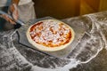 Pizza on shovel in hands of the chef in kitchen Royalty Free Stock Photo