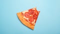 Pizza slice on blue background