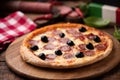 Pizza slice with olives and salami toping