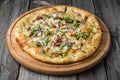 Pizza with sun-dried tomatoes, prosciutto, arugula and parmesan cheese Royalty Free Stock Photo