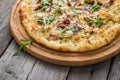 Pizza with sun-dried tomatoes, prosciutto, arugula and parmesan cheese