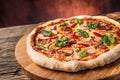 Pizza. Tasty fresh italian pizza with bacon cihili pepper spinach and onion served on old wooden table Royalty Free Stock Photo