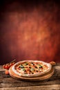 Pizza. Tasty fresh italian pizza served on old wooden table Royalty Free Stock Photo