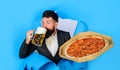 Pizza time. Bearded man with pizza drinks beer mug. Pizza delivery. Business lunch. Restaurant or pizzeria. Fast food Royalty Free Stock Photo
