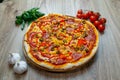 Pizza with tomato sauce, salami, green olives, corn, cheese and red bell pepper top angle view