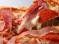Pizza with tomatoes and meat. Slice of pizza with cheese and jamon. Italian cuisine